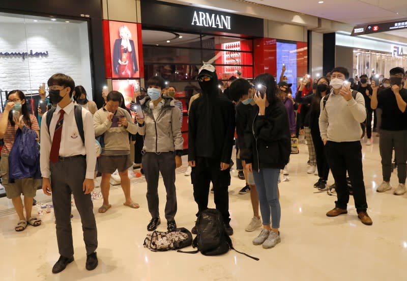 Protesters stand during an anti-government protest at Yoho Mall in Yuen Long, Hong Kong