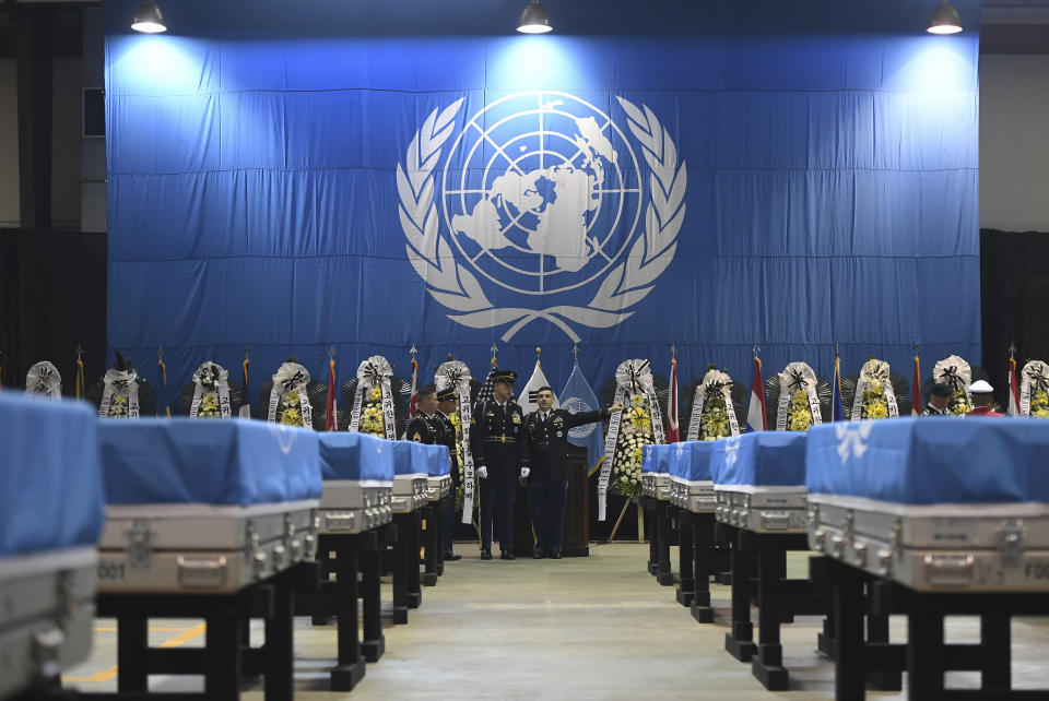 United Nations Command honor guards inspect caskets containing the remains of U.S. soldiers who were killed in the Korean War and collected in North Korea before a repatriation ceremony at Osan Air Base in Pyeongtaek, South Korea, on Wednesday, Aug. 1, 2018. North Korea handed over 55 boxes of the remains last week as part of agreements reached during a historic June summit between its leader Kim Jong Un and U.S. President Donald Trump. (Jung Yeon-je/Pool Photo via AP)