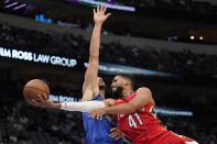 New Orleans Pelicans forward Garrett Temple (41) shoots as Dallas Mavericks' Maxi Kleber defends during the first half of an NBA basketball game in Dallas, Friday, Dec. 3, 2021. (AP Photo/Tony Gutierrez)