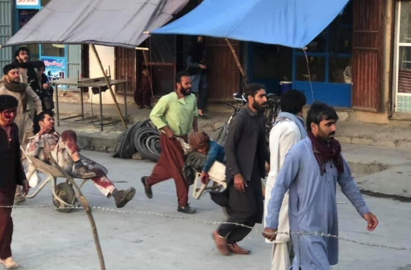 Two injured people are escorted away from the scene in wheelbarrows. Source: Twitter