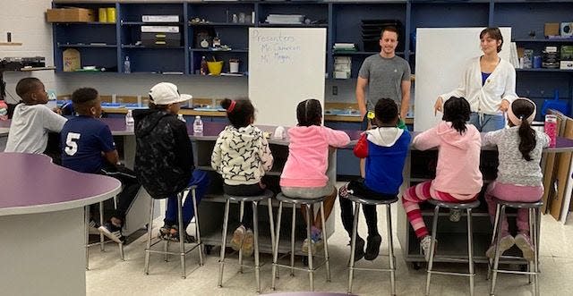 In a session at Aspiration Academy, Cameron Burrows and Megan Landin of Codecraft Works teach kids about coding.