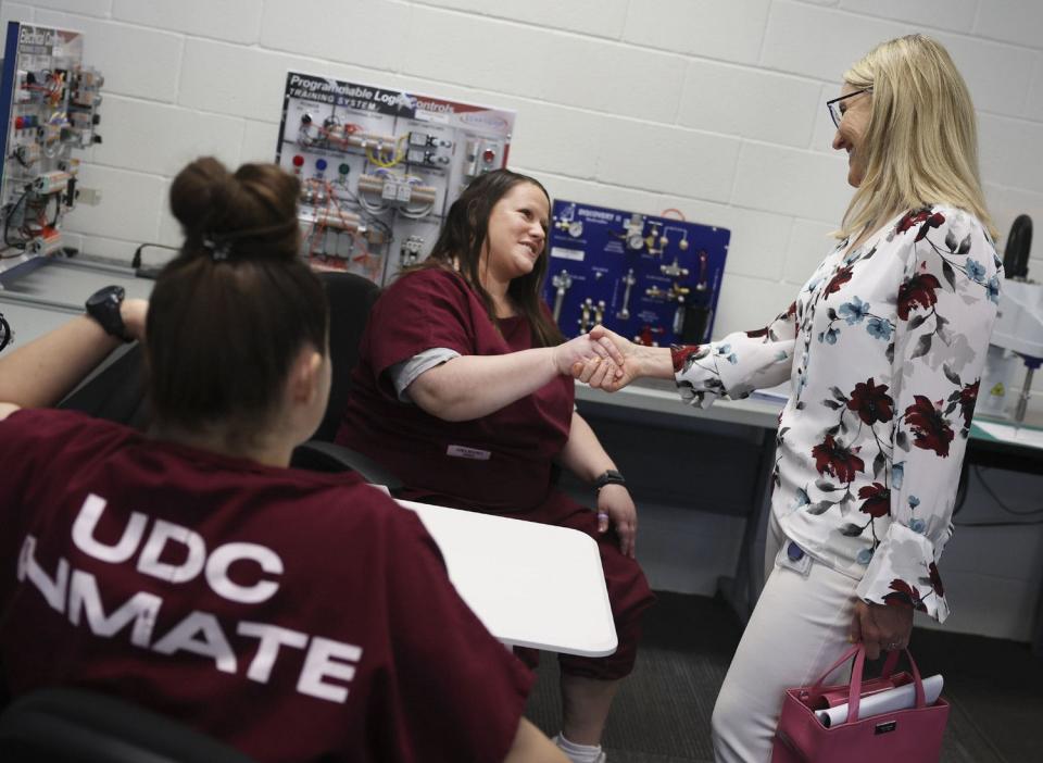 Jessica Luna, left, and Miranda Jones speak with Rep. Melissa Garff Ballard, R-North Salt Lake, in the automation and robotics class at the Utah State Correctional Facility in Salt Lake City on Friday.