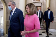 Senate Minority Leader Sen. Chuck Schumer of N.Y., left, and House Speaker Nancy Pelosi of Calif., right, walk out of a meeting with Treasury Secretary Steven Mnuchin and White House Chief of Staff Mark Meadows as they continue to negotiate a coronavirus relief package on Capitol Hill in Washington, Friday, Aug. 7, 2020. (AP Photo/Andrew Harnik)