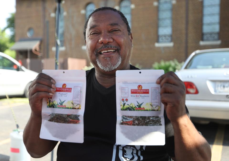 Richard McCollough with bags of leaf tea at his Weatherfield Farm stand at the Westside Farmers Market.