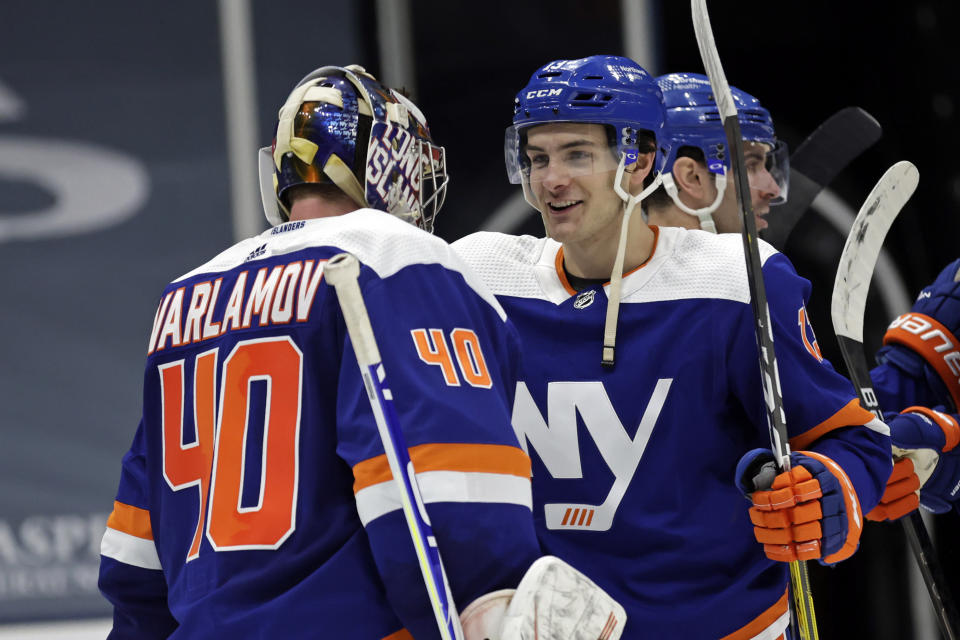 New York Islanders center Mathew Barzal celebrates with goaltender Semyon Varlamov (40) after the team's 4-2 win over the Boston Bruins in an NHL hockey game, Saturday, Feb. 13, 2021, in Uniondale, N.Y. (AP Photo/Adam Hunger)