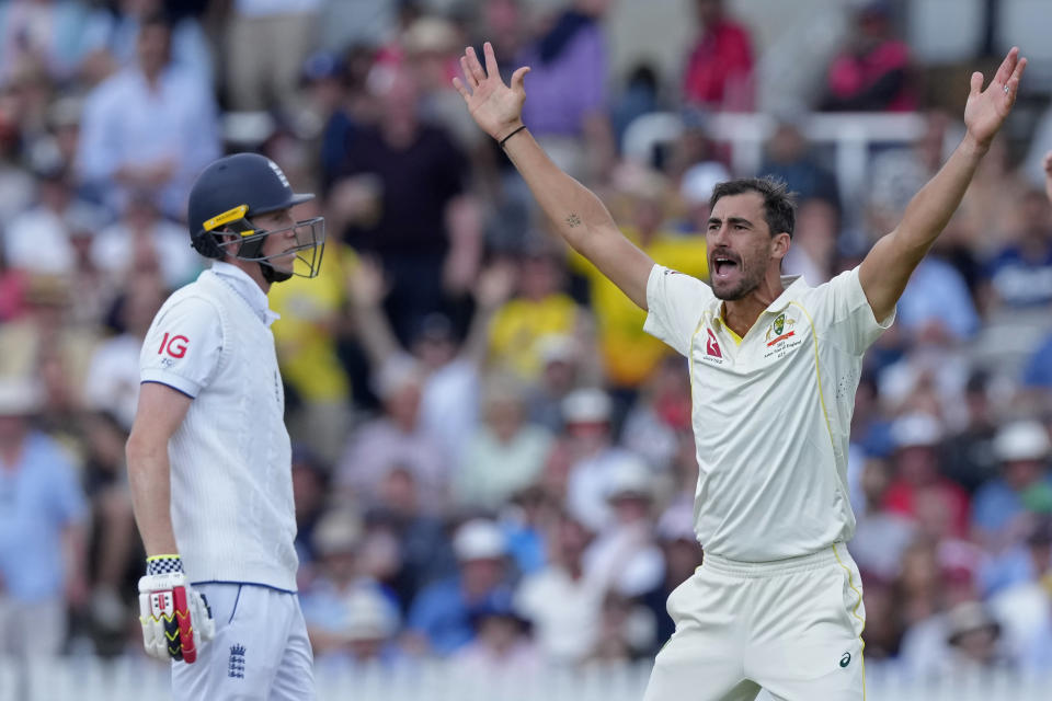 Australia's Mitchell Starc, right, celebrates the dismissal of England's Zak Crawley, left, during the fourth day of the second Ashes Test match between England and Australia, at Lord's cricket ground in London, Saturday, July 1, 2023. (AP Photo/Kirsty Wigglesworth)