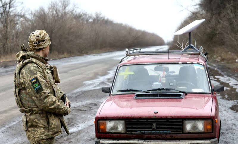 FILE PHOTO: A Ukrainian serviceman stands next to a vehicle that carries a Starlink satellite internet system near the frontline