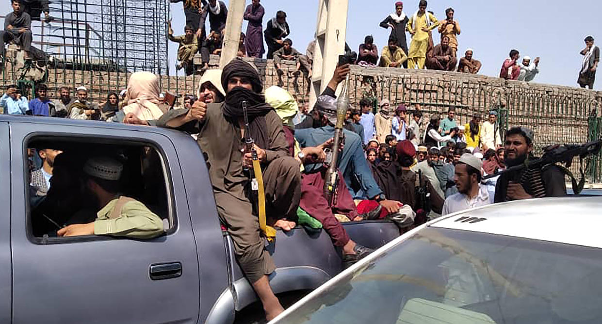 Taliban fighters sit on a vehicle along the street in Jalalabad province on August 15, 2021. (-/AFP via Getty Images)