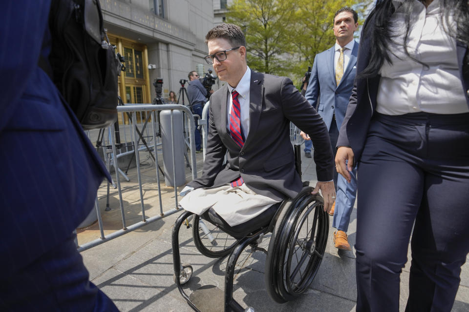 Brian Kolfage leaves court after being sentenced for defrauding donors to the "We Build the Wall" effort, Wednesday, April 26, 2023, in New York. The co-founder of a fundraising group linked to Steve Bannon that promised to help Donald Trump construct a wall along the southern U.S. border has been sentenced to four years and three months in prison. (AP Photo/John Minchillo)
