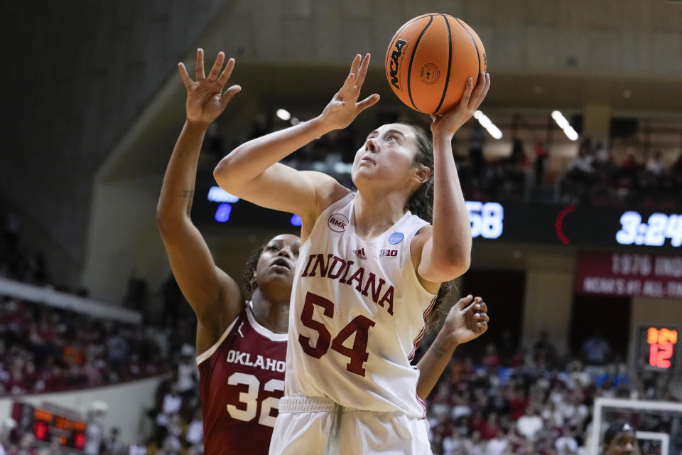 Indiana forward Mackenzie Holmes (54) shoots in front of Oklahoma forward Sahara Williams (32) in the second half of a second-round college basketball game in the NCAA Tournament, Monday, March 25, 2024, in Bloomington, Ind. Indiana defeated Oklahoma 75-68. (AP Photo/Michael Conroy)