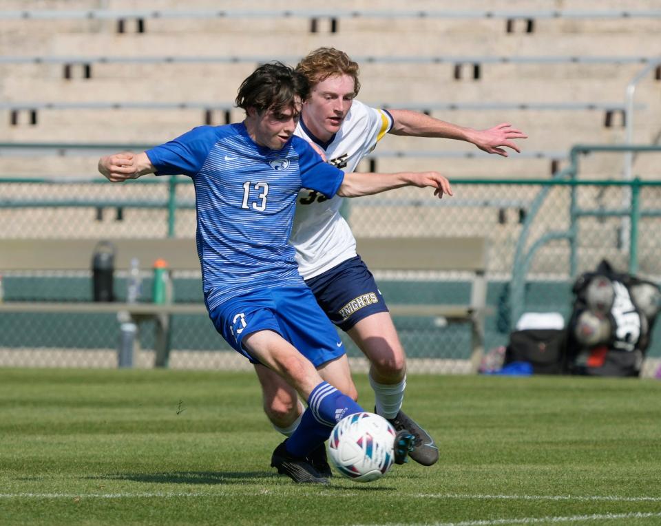 The Canterbury School Walter Ballard (13) battles with The Pine School Christian Kerr during the Class 2A Boys Soccer Championship match at Spec Martin Stadium in DeLand, Thursday, Feb. 23, 2023 The Pine School won the championship 2-1.