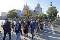FILE - In this Saturday, Oct. 5, 2019, file photo, people arrive for The Church of Jesus Christ of Latter-day Saints' twice-annual church conference, in Salt Lake City. For the first time in more than 60 years, top leaders from The Church of Jesus Christ of Latter-day Saints will deliver speeches at the faith's signature conference this weekend without anyone watching in the latest illustration of how the coronavirus pandemic is altering worship practices around the world. The twice-yearly conference normally brings some 100,000 people to the church conference center in Salt Lake City to watch five sessions over two days. This event, though, will be only a virtual one. (AP Photo/Rick Bowmer, File)