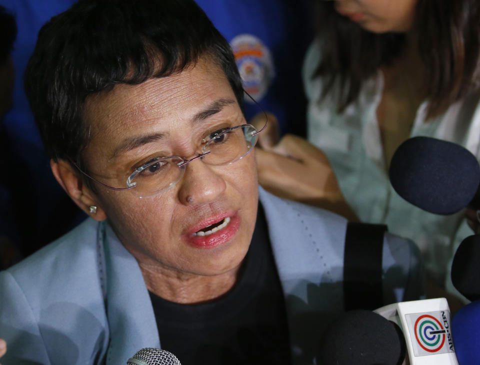 FILE - Maria Ressa, the award-winning head of a Philippine online news site Rappler, talks to the media after posting bail at a Regional Trial Court following an overnight arrest by National Bureau of Investigation agents on a libel case in Manila, Philippines on Feb. 14, 2019. A new documentary tracks Ressa’s dual life in recent years. She’s seen smiling while accepting international honors and praise from the likes of George Clooney, then grimly facing down online harassment, legal action and real world threats for her news site’s reporting on the drug war waged by President Rodrigo Duterte. (AP Photo/Bullit Marquez, File)