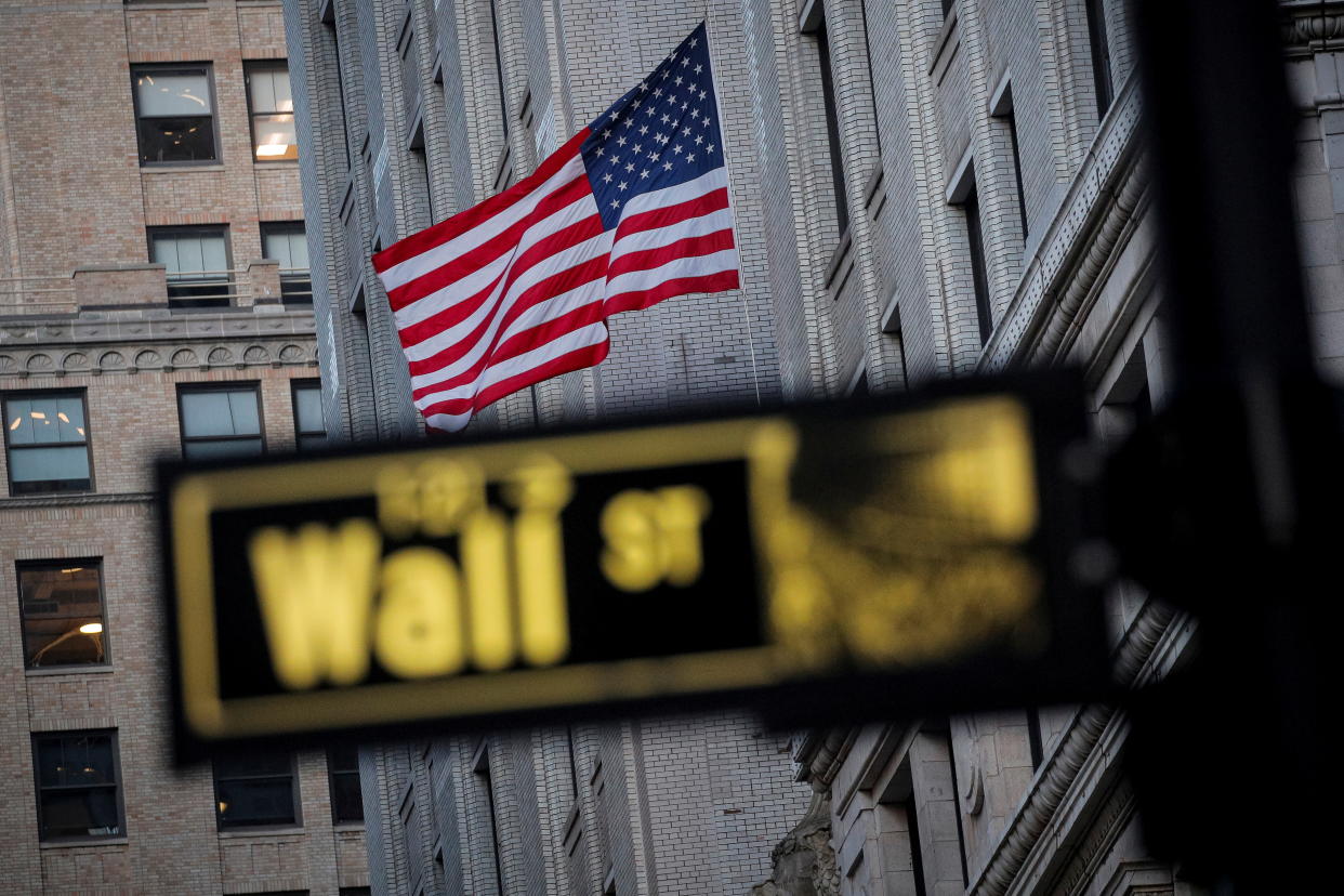 The U.S. flag is seen on a building on Wall St. in the financial district in New York, U.S., November 24, 2020. REUTERS/Brendan McDermid