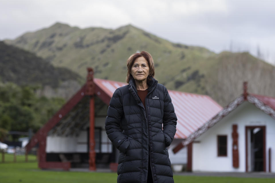 Jula Teki, known as "Aunty Sugar," stands for a portrait near the Otukopiri marae (meeting grounds) which she runs on the banks of the Whanganui River in the town of Koriniti, New Zealand, on June 15, 2022. “They call us the river rats. And we are the river people, the people of the river,” she says. “When the river is flowing good, everything is okay. When it's flooded, we just all hunker down and we know how the river’s going to react. The road’s probably going to close down, but that doesn’t mean anything to us.” (AP Photo/Brett Phibbs)