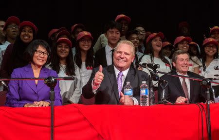 Toronto mayoral candidates Olivia Chow (L), Doug Ford (C) and John Tory pose with school children after a municipal debate for the upcoming city election in Toronto in this September 23, 2014 file photo. REUTERS/Mark Blinch/Files