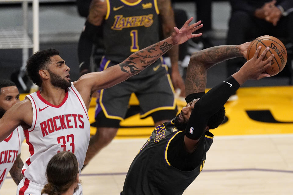 Los Angeles Lakers center Andre Drummond, right, grabs a rebound away from Houston Rockets forward Anthony Lamb during the first half of an NBA basketball game Wednesday, May 12, 2021, in Los Angeles. (AP Photo/Mark J. Terrill)