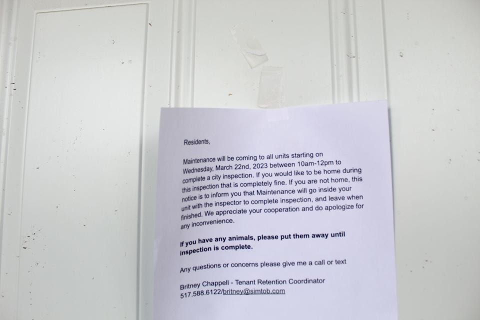 A message is placed on a unit's front door at Holmes Apartments in Lansing on March 22, 2023, informing residents about a city inspection.