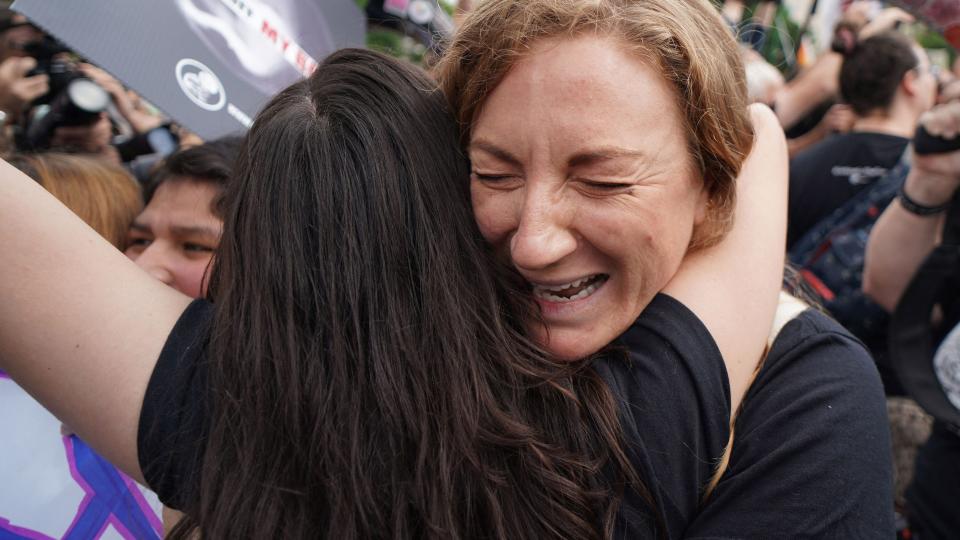 Pro-life activists hug outside the US Supreme Court in Washington, DC, on June 24, 2022. - The US Supreme Court on Friday ended the right to abortion in a seismic ruling that shreds half a century of constitutional protections on one of the most divisive and bitterly fought issues in American political life. The conservative-dominated court overturned the landmark 1973 