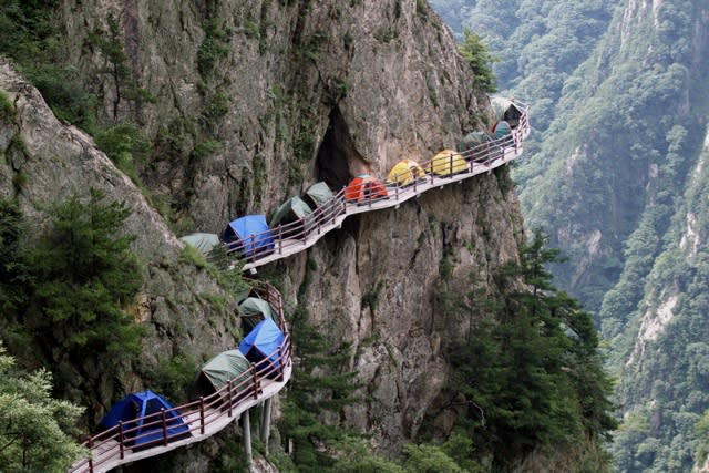 Tourists set up camp on 1,700m high cliff edge