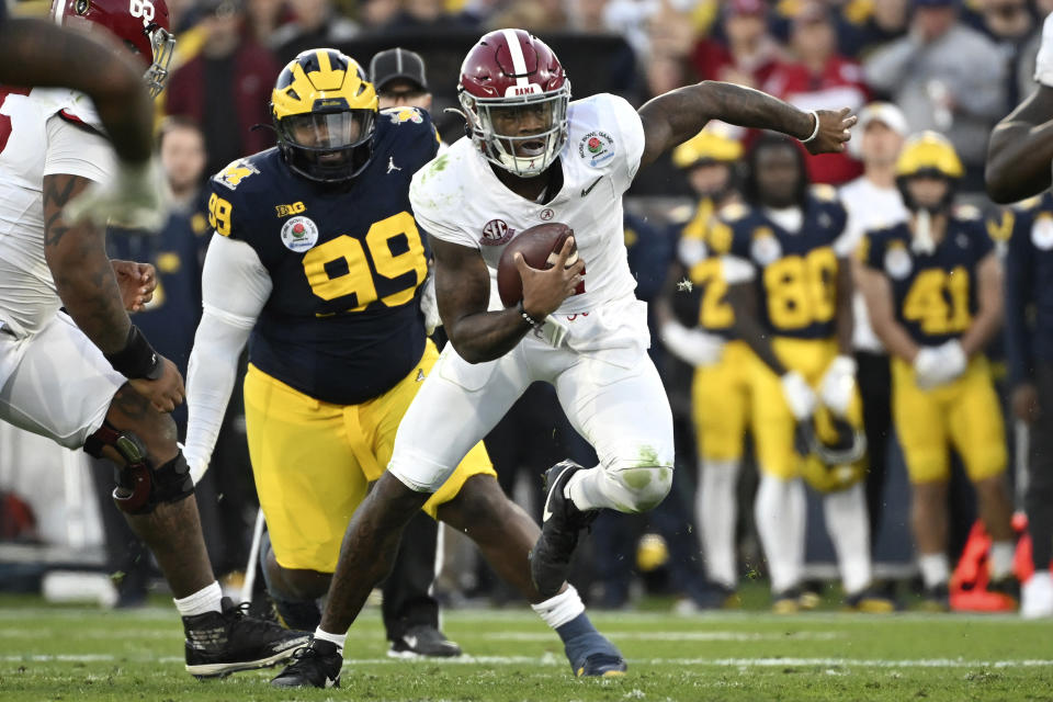 Alabama quarterback Jalen Milroe (4) runs the ball past Michigan defensive lineman Cam Goode (99) during the second half of the Rose Bowl CFP NCAA semifinal college football game against Michigan Monday, Jan. 1, 2024, in Pasadena, Calif. (AP Photo/Kyusung Gong)