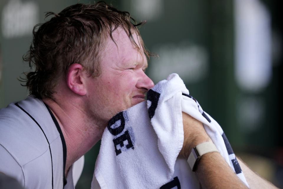 San Francisco Giants trainer Dave Groeschner applies a cold wet towel to the face of starting pitcher Logan Webb during the fourth inning of a baseball game against the Chicago Cubs Monday, Sept. 4, 2023, in Chicago. (AP Photo/Charles Rex Arbogast)