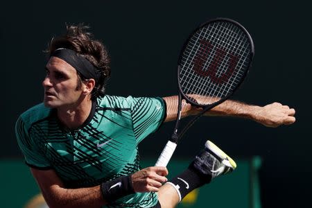 Mar 27, 2017; Miami, FL, USA; Roger Federer of Switzerland serves against Juan Martin del Potro of Argentina (not pictured) on day seven of the 2017 Miami Open at Crandon Park Tennis Center. Mandatory Credit: Geoff Burke-USA TODAY Sports