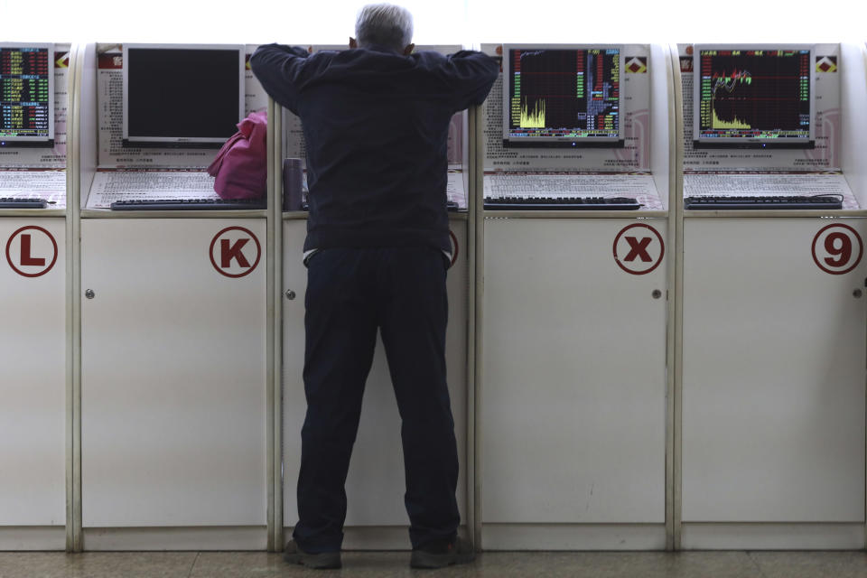 A Chinese man monitors stock prices at a brokerage in Beijing, Friday, Oct. 19, 2018. Asian stock markets sank Friday after Wall Street declined on losses for tech and industrial stocks and Chinese economic growth slowed. (AP Photo/Ng Han Guan)