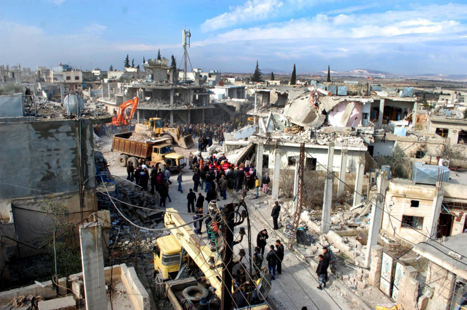 In this photo released by the Syrian official news agency SANA, Syrian citizens gather at site where a car bomb has exploded near a school, at al-Kaffat village in the central Hama province, Syria, Thursday Jan. 9, 2013. Syrian state media and an opposition watchdog say a car bomb has exploded near a school in a central province, killing several people and wounding dozens. (AP Photo/SANA)