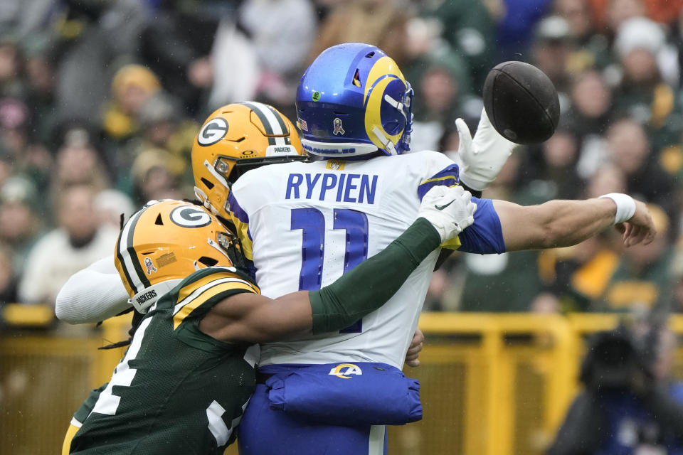 Los Angeles Rams quarterback Brett Rypien (11) fumbles the football while hit by Green Bay Packers cornerback Jaire Alexander (23), front left, during the first half of an NFL football game Sunday, Nov. 5, 2023, in Green Bay, Wis. (AP Photo/Morry Gash)