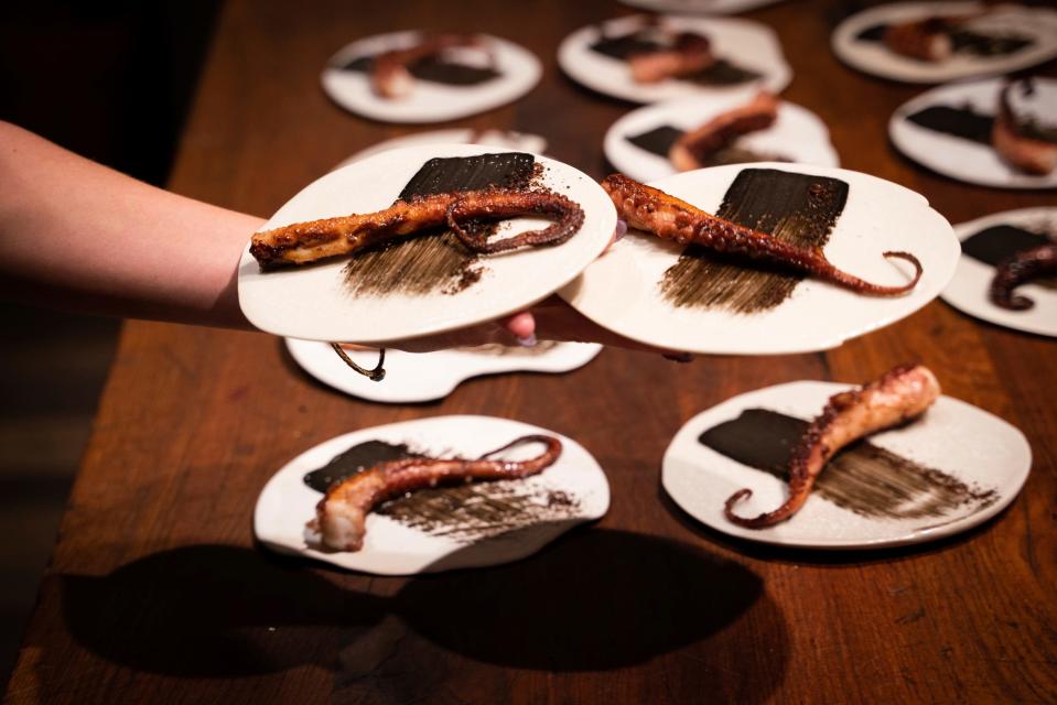 Charred octopus is plated and served to guests during Tablescape, a dinner that merges art and food, at Marrow in Detroit on Friday, Sept. 8, 2023.