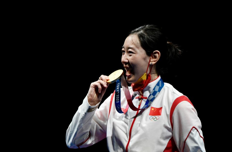 China's Sun Yiwen bites her gold medal.