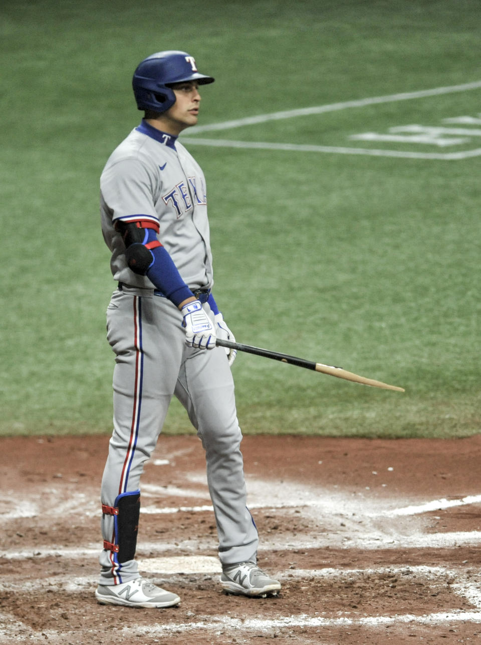 Texas Rangers' Nate Lowe hold his broken bat during the seventh inning of a baseball game against the Tampa Bay Rays Monday, April 12, 2021, in St. Petersburg, Fla. (AP Photo/Steve Nesius)