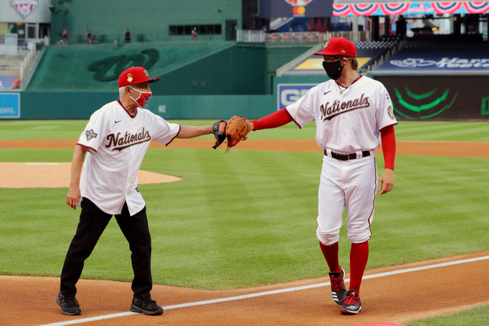 Director of the National Institute of Allergy and Infectious Diseases Dr. Anthony Fauci is greeted by Sean Doolittle #63 of the Washington Nationals after throwing out the ceremonial first pitch prior to the game between the New York Yankees and the Washington Nationals at Nationals Park on Thursday, July 23, 2020 in Washington, District of Columbia. (Photo by Alex Trautwig/MLB Photos via Getty Images)