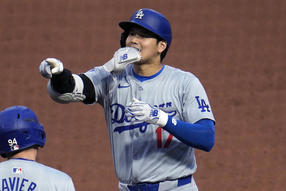Los Angeles Dodgers' Shohei Ohtani (17) celebrates as he stands on first after hitting a single off Pittsburgh Pirates starting pitcher Paul Skenes during the fifth inning of a baseball game in Pittsburgh, Wednesday, June 5, 2024. (AP Photo/Gene J. Puskar)
