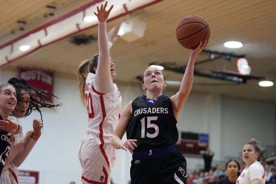 Holy Cross guard Cara McCormack (15) takes a shot at the basket as Boston University guard Lauren Davenport defends in the second half of an NCAA women's Patriot League college basketball championship game, Sunday, March 12, 2023, in Boston. (AP Photo/Steven Senne)