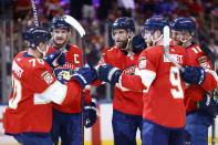 Florida Panthers defenseman Aaron Ekblad (5) celebrates with teammates after scoring a goal against the Arizona Coyotes during the second period of an NHL hockey game, Monday, Oct. 25, 2021, in Sunrise, Fla. (AP Photo/Michael Reaves)