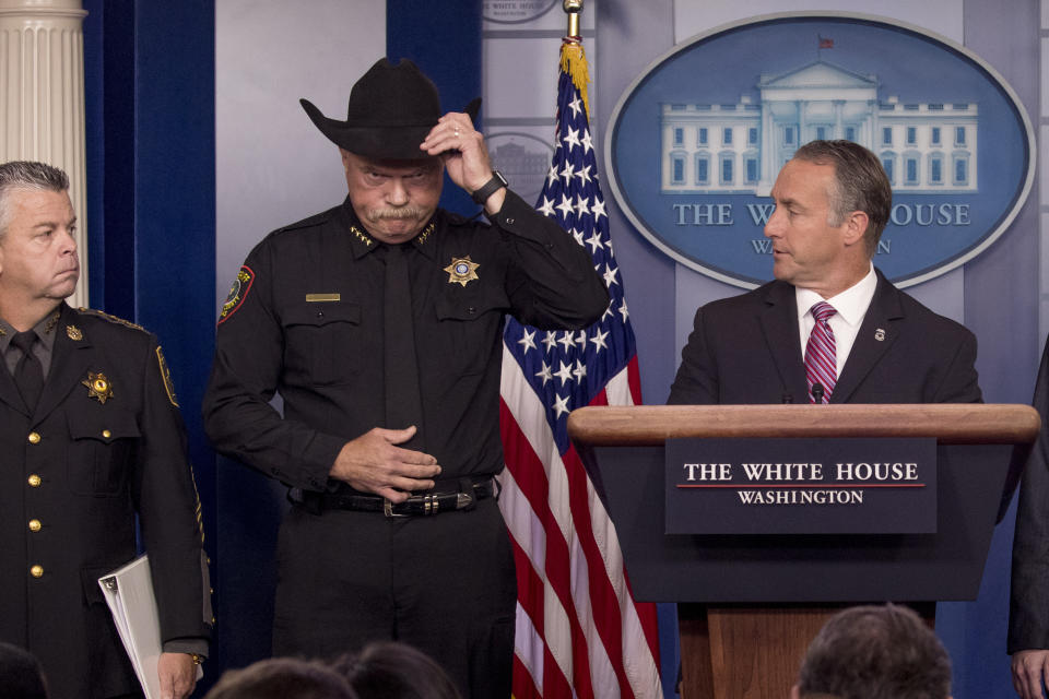 Immigration and Customs Enforcement Director Matt Albence, right, accompanied by sheriffs from around the country including Tarrant County, Texas Sheriff Bill Waybourn, center, speaks in the Briefing Room at the White House in Washington, Thursday, Oct. 10, 2019. (AP Photo/Andrew Harnik)