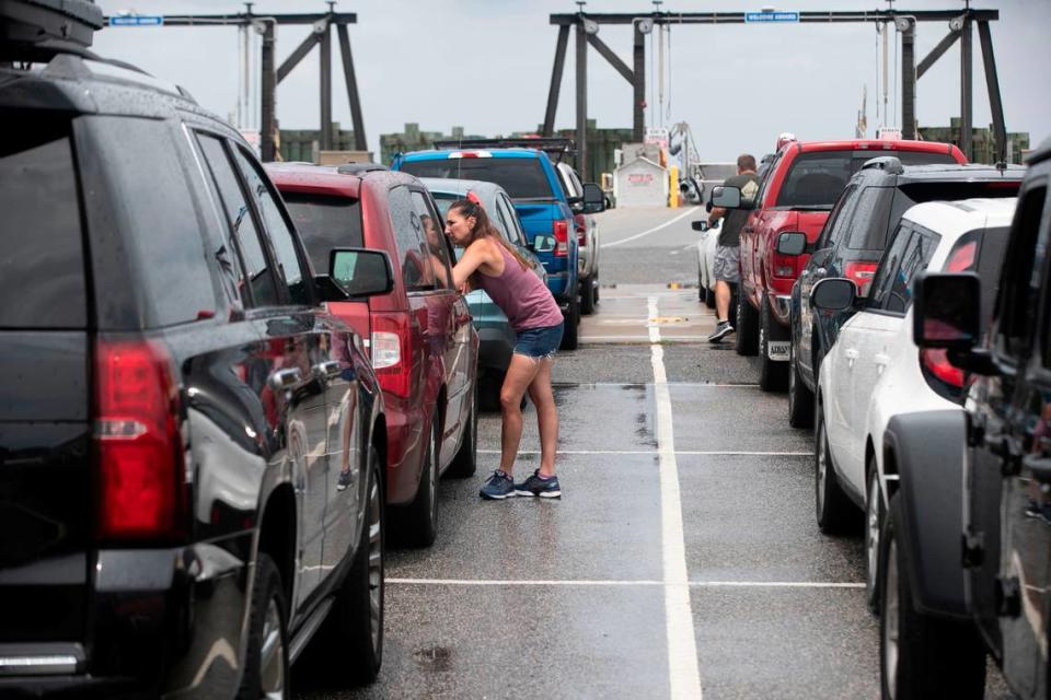 Passengers wait in line to board the ferry from Hatteras to Ocracoke on Wednesday, July 21, 2021 in Hatteras, N.C.