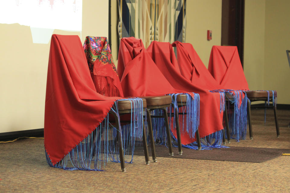 Red shawls drape chairs at the front of the room as families and victim advocates mark Missing and Murdered Indigenous Persons Awareness Day at the Indian Pueblo Cultural Center in Albuquerque, N.M., Sunday, May 5, 2024. The shawls represent relatives who have gone missing or have been killed in what many have described as a crisis in Indian Country. (AP Photo/Susan Montoya Bryan)