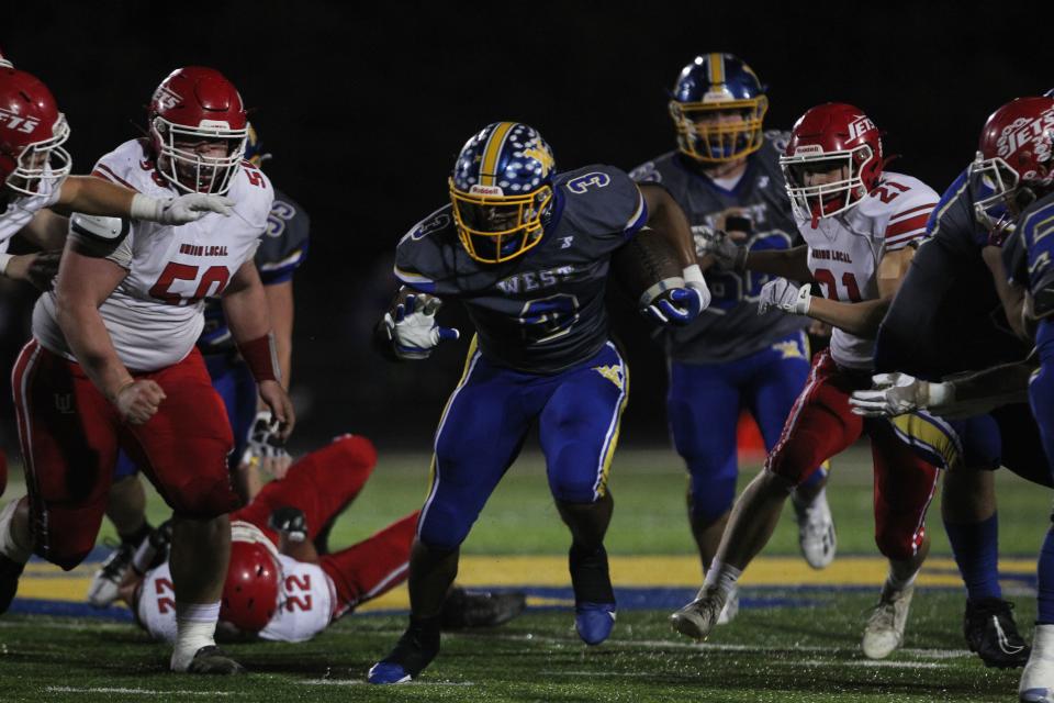 West Muskingum's Rashid SeSay carries the ball against Union Local.