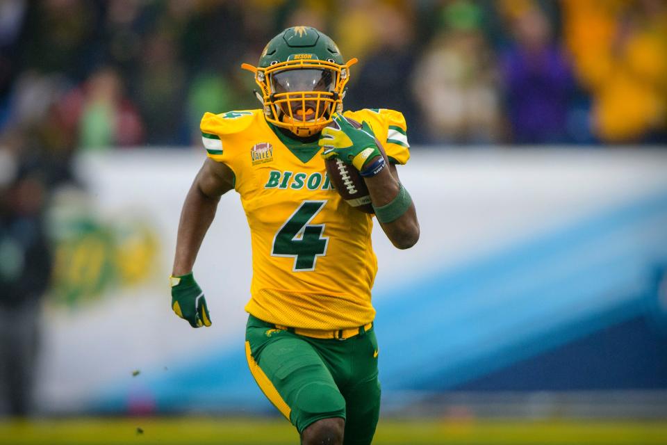 Jan 8, 2022; Frisco, TX, USA; North Dakota State Bison running back Kobe Johnson (4) rushes for a touchdown against the Montana State Bobcats during the first half of the FCS Championship at Toyota Stadium.