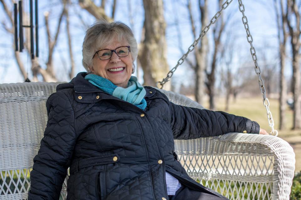 Sandy Prantera, 82, sits on her porch near where construction is underway on a bridge located on 33 Mile Road in Armada Township on March 29, 2022.