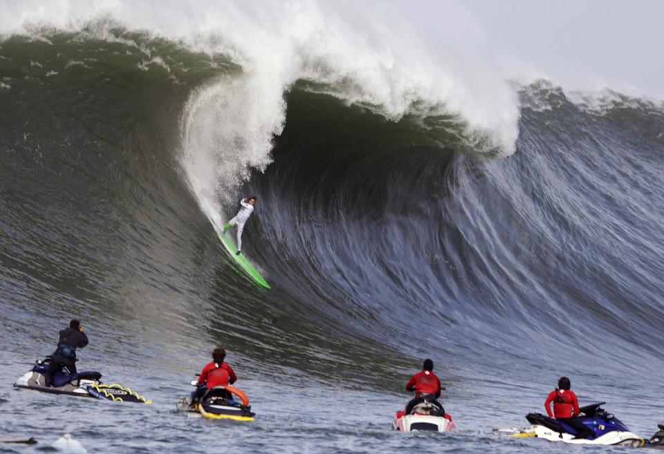 Nic Lamb rides a wave during the third heat of the first round of the Mavericks Invitational big wave surf contest Friday, Jan. 24, 2014, in Half Moon Bay, Calif. (AP Photo/Eric Risberg)