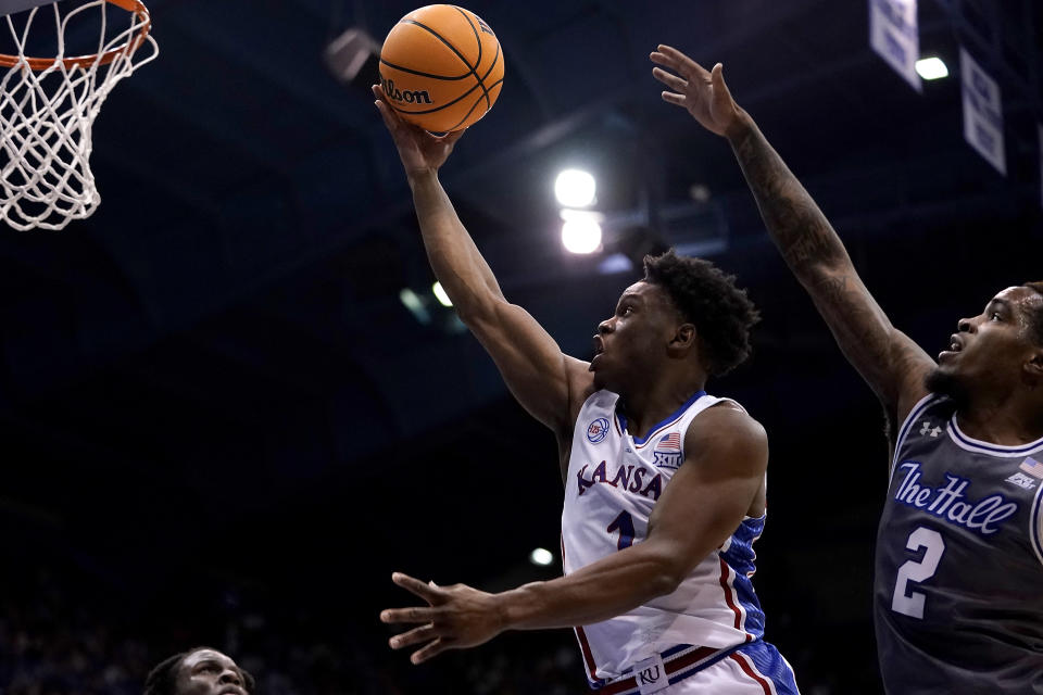 Kansas guard Joseph Yesufu (1) gets past Seton Hall guard Al-Amir Dawes (2) to put up a shot during the first half of an NCAA college basketball game Thursday, Dec. 1, 2022, in Lawrence, Kan. (AP Photo/Charlie Riedel)
