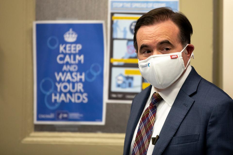 Mayor John Cranley walks into the press conference to provide an update on the COVID-19 pandemic ahead of the holidays on Tuesday, Dec. 21, 2021, in Cincinnati.