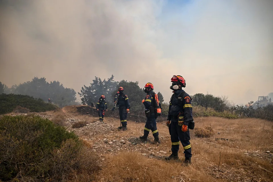 Greek firefighters work to extinguish wildfires near the village of Vati, just north of the coastal town of Gennadi, in the southern part of the Greek island of Rhodes, on July 25, 2023. Some 30,000 people fled the flames on Rhodes during the weekend, the country's largest-ever wildfire evacuation as the Greek Prime Minister warned that the heat-battered nation was 