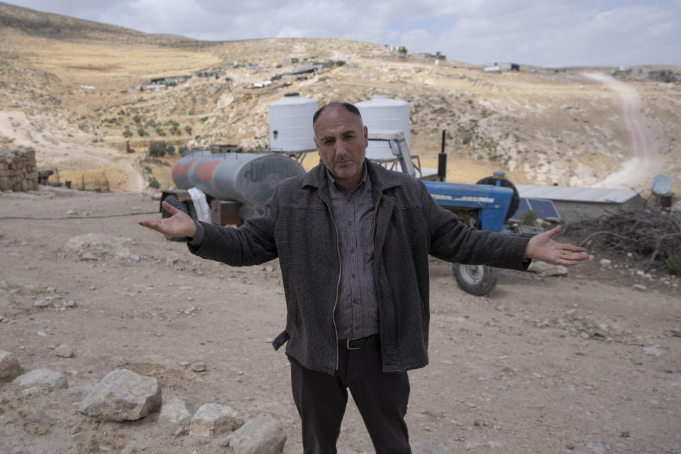 Head of the Palestinian Beduin communities of Masafer Yatta, Nidal Younes talks to reporters in the West Bank Beduin community of Jinba, Masafer Yatta, Friday, May 6, 2022. Israel's Supreme Court has upheld a long-standing expulsion order against eight Palestinian hamlets in the occupied West Bank, potentially leaving at least 1,000 people homeless. (AP Photo/Nasser Nasser)