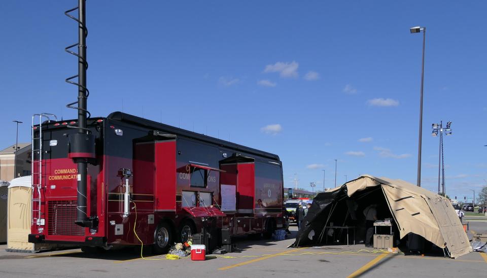 A communication command station is set up Saturday at the Dillons parking lot in Andover after a tornado tore through the community the night before.