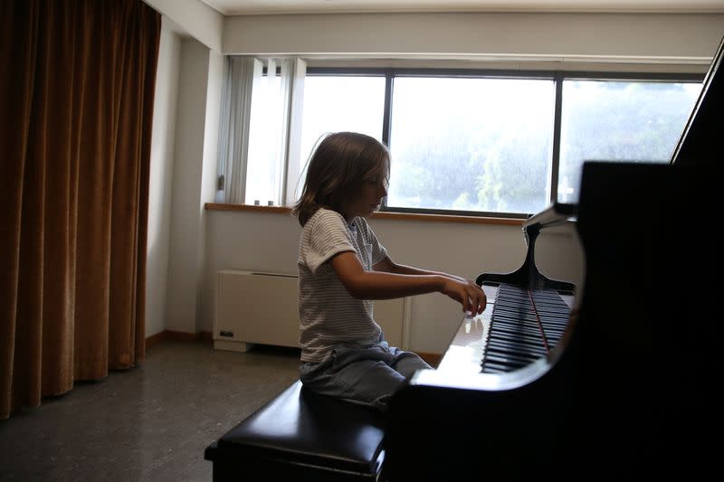 Stelios Kerasidis, 7-year-old pianist and composer, plays the piano during a lesson at the Athens Megaron Concert Hall in Athens